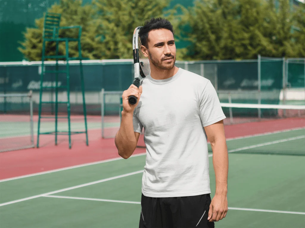 a men playing tennis in white tshirt